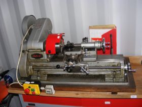 A Myford bench mounted lathe with manual etc.