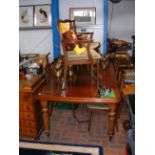 A Victorian style mahogany extending dining table on fluted legs