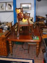 A Victorian style mahogany extending dining table on fluted legs