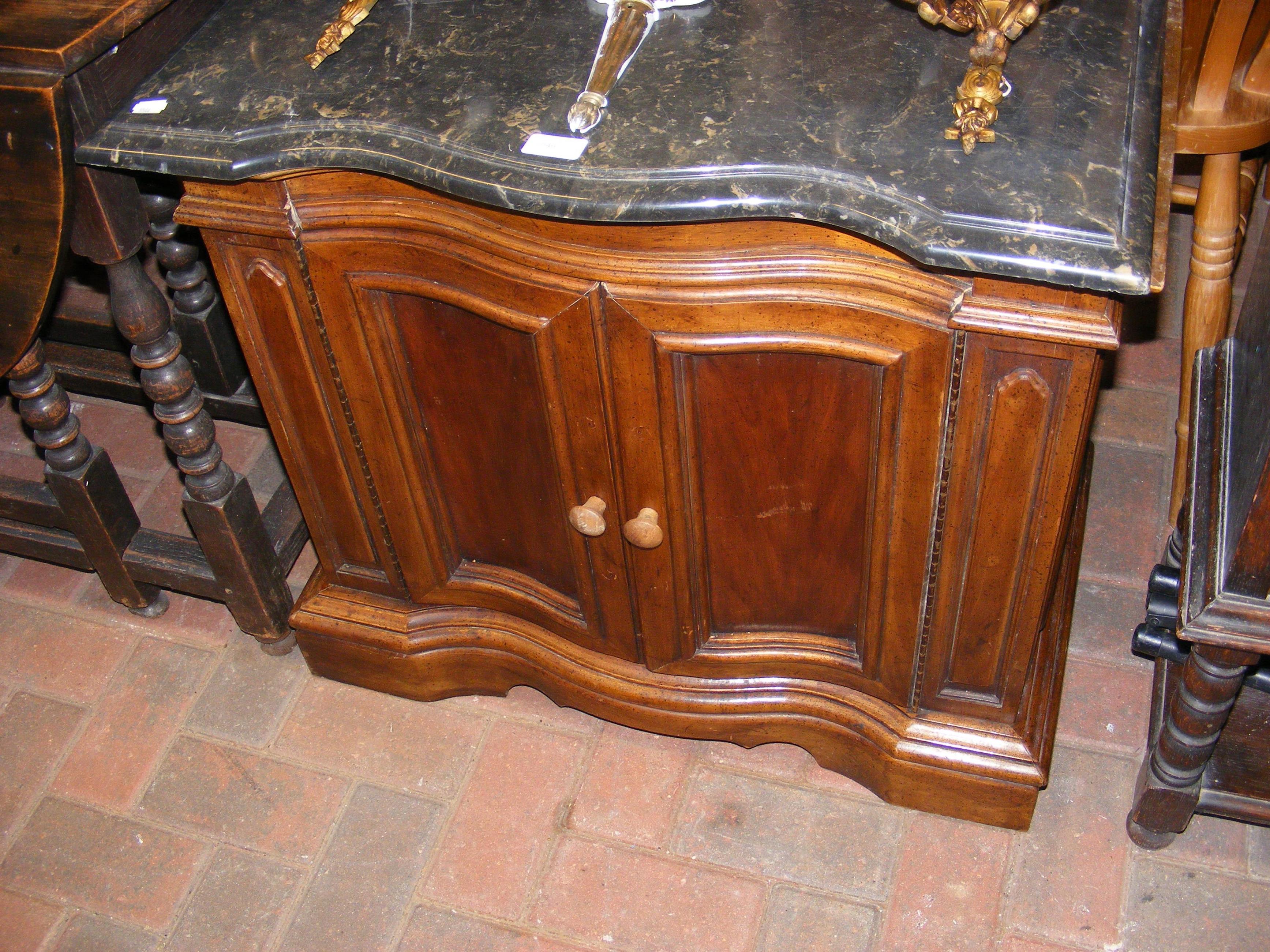 An antique serpentine fronted cabinet with marble