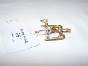An unusual greyhound brooch in gold mount