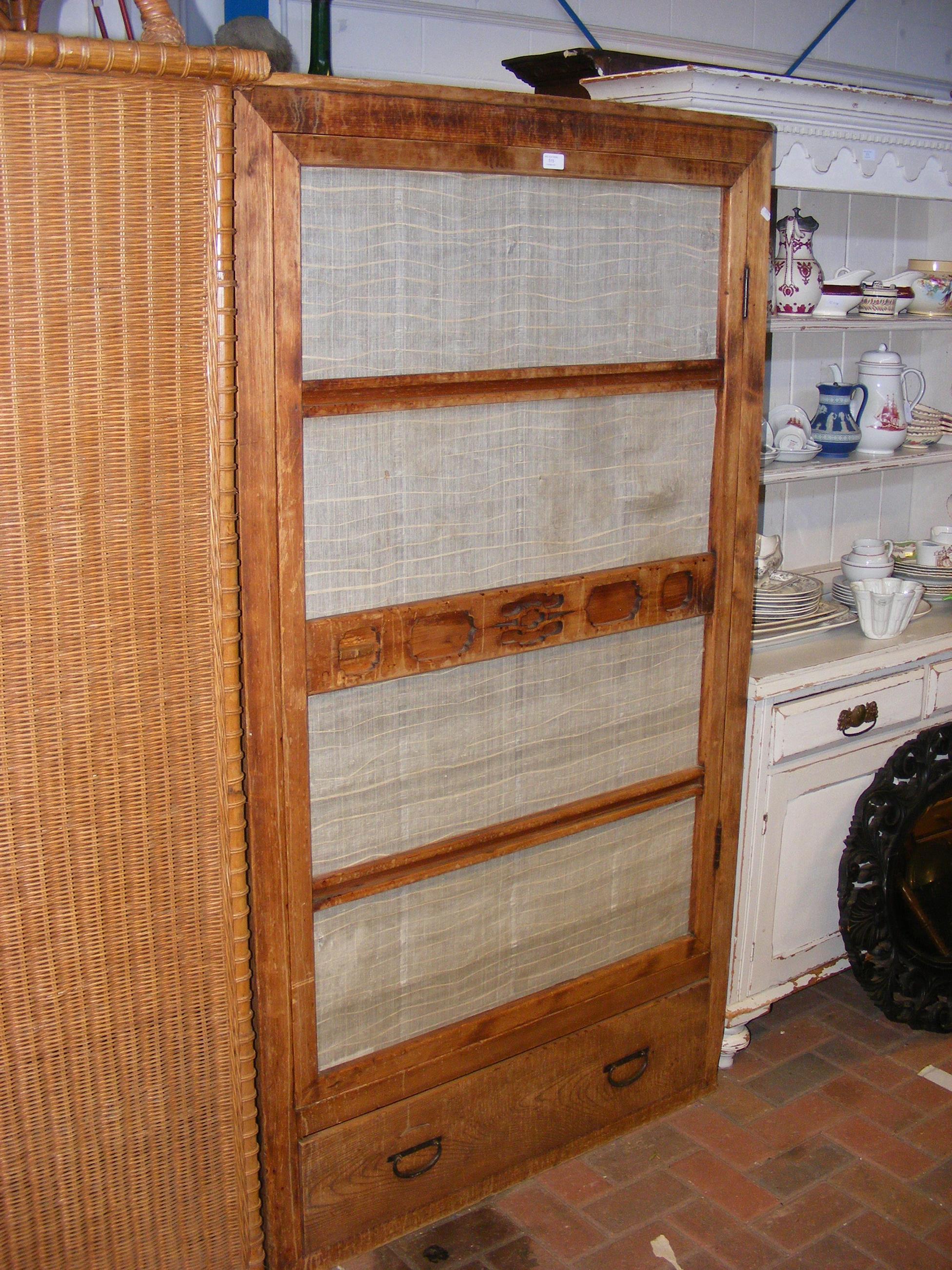 An Asian style wardrobe with single door to front