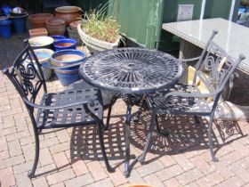 A black and metal bistro garden table with two cha