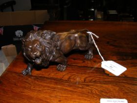 A bronze style ornamental lion - 15cms long