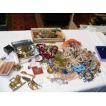 A plastic box containing costume jewellery includi