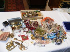 A plastic box containing costume jewellery includi
