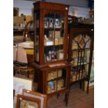 A slender Edwardian inlaid mahogany breakfront dis