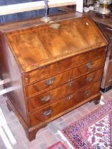 A Georgian walnut bureau with two short and two lo