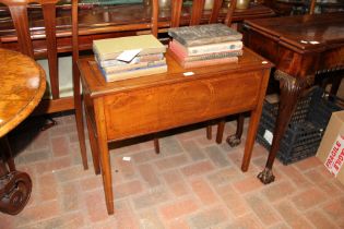 An antique sewing cabinet with fitted interior con