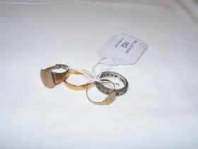 A 22ct gold wedding band together with three dress