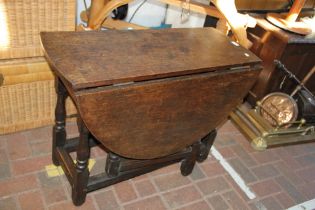 An antique gate-leg table