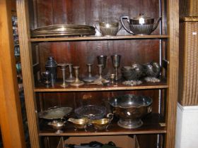 Three shelves of silver plate