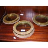 Three brass portholes