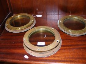 Three brass portholes