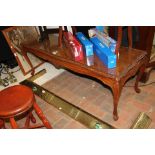 A burr walnut coffee table on cabriole supports
