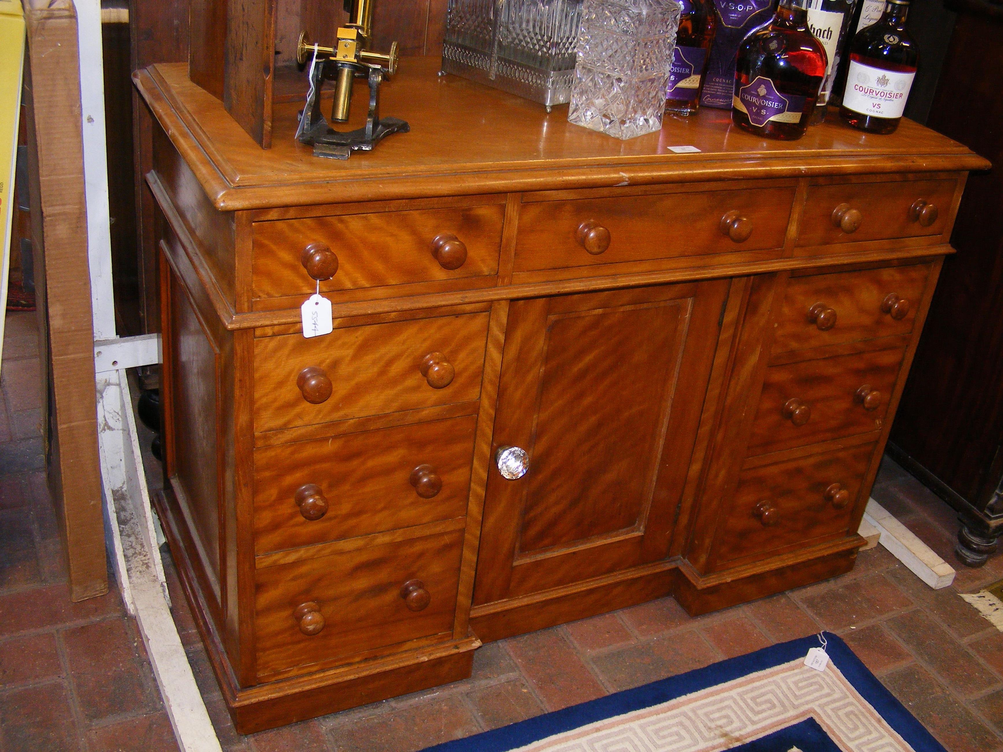 A Victorian pedestal desk with nine drawers to the