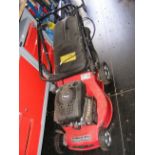 A petrol driven Mountfield lawnmower with grass bo