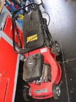 A petrol driven Mountfield lawnmower with grass bo