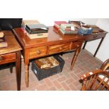 An antique mahogany three drawer side table on tur