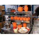 A collection of Le Creuset orange glaze ceramic wa