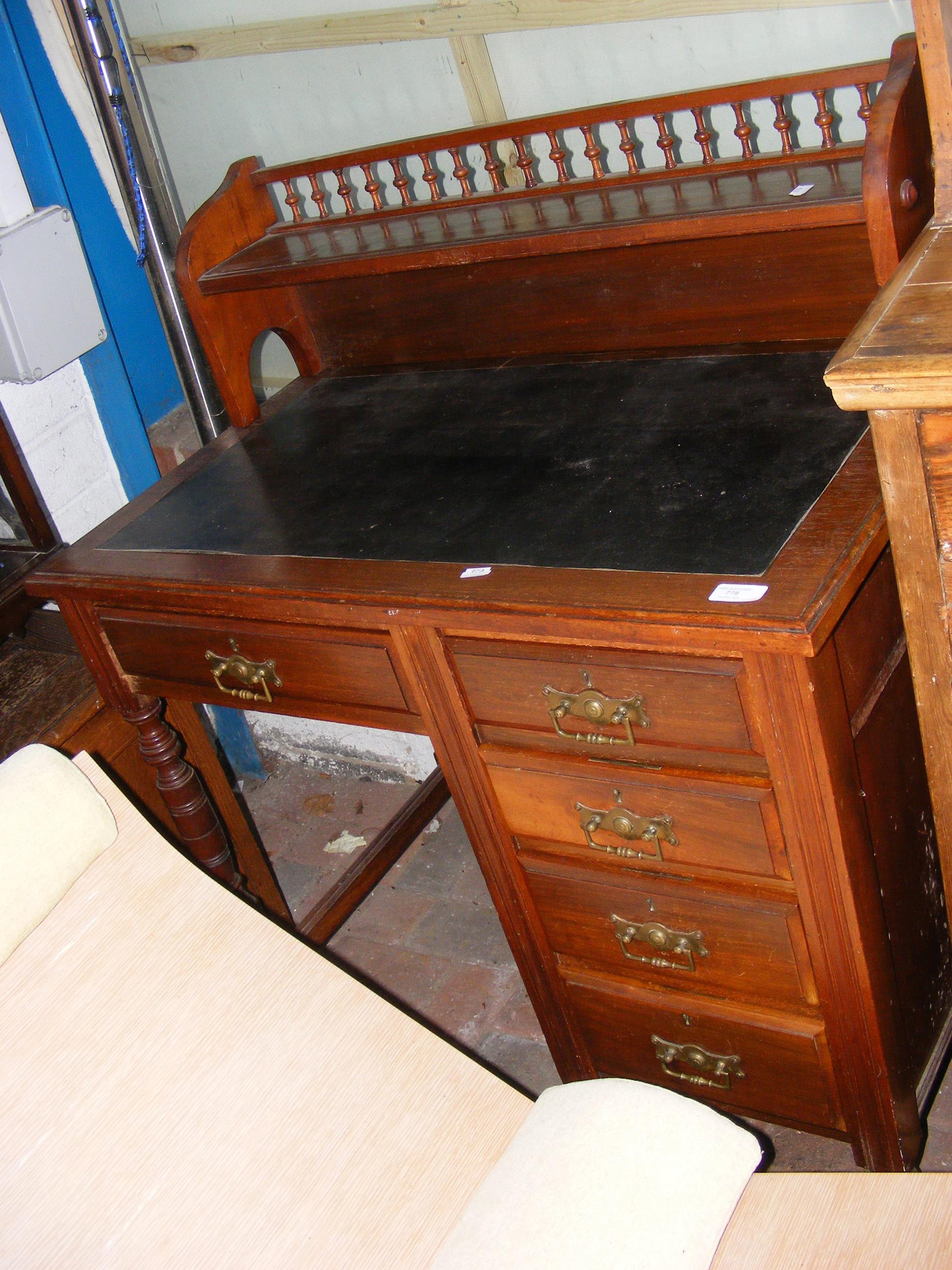 An Edwardian mahogany writing desk with inset blac