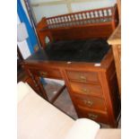 An Edwardian mahogany writing desk with inset blac