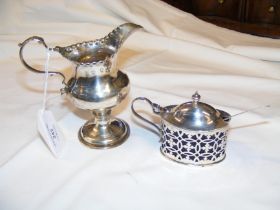 A silver cream jug together with mustard pot
