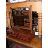 An antique toilet mirror with two drawers to the f