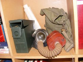 A WWII era gas mask, together with other Army item