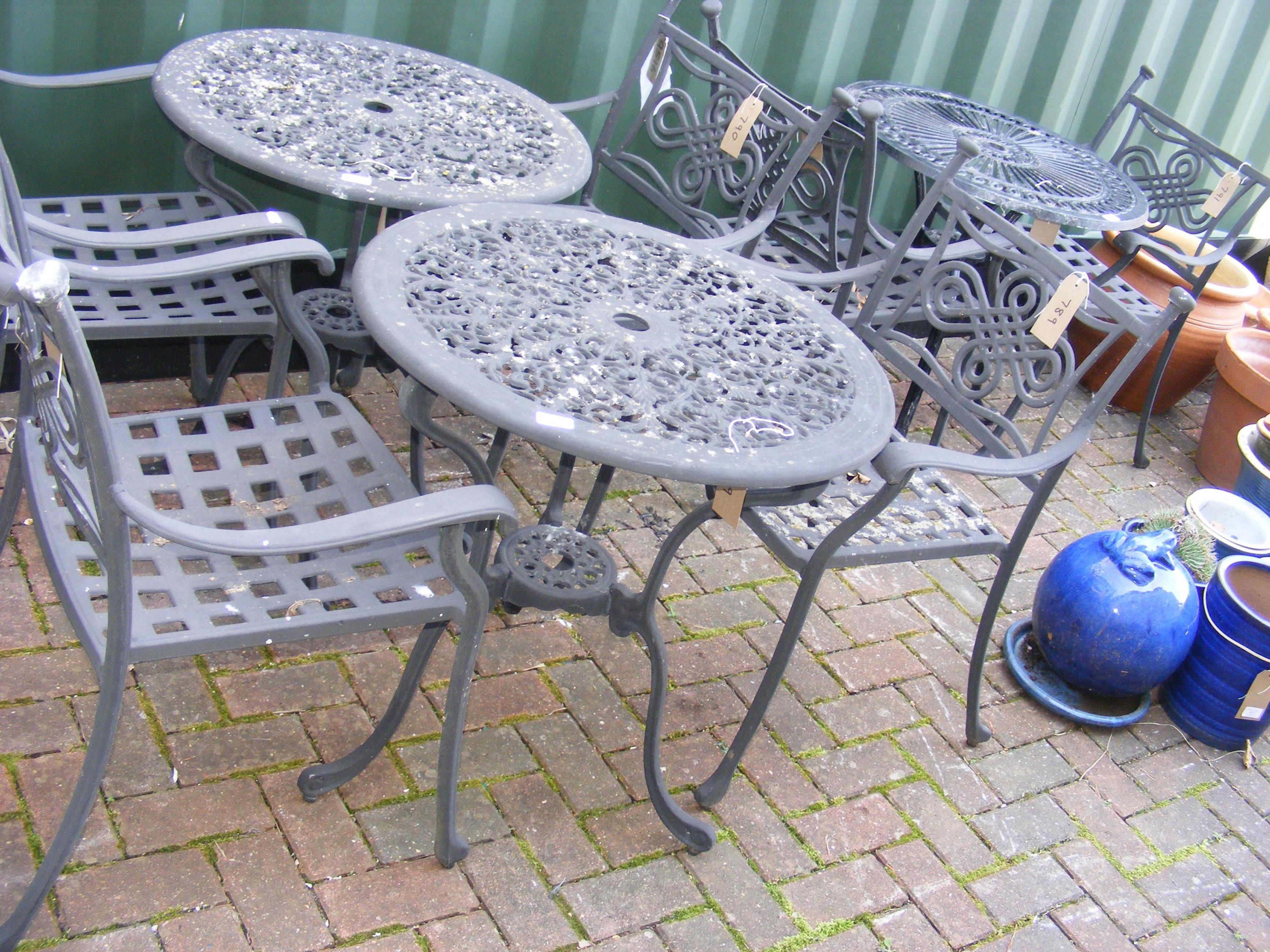 A black and metal bistro garden table with two cha