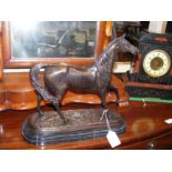 A reproduction bronze horse ornament on marble pli