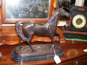 A reproduction bronze horse ornament on marble pli