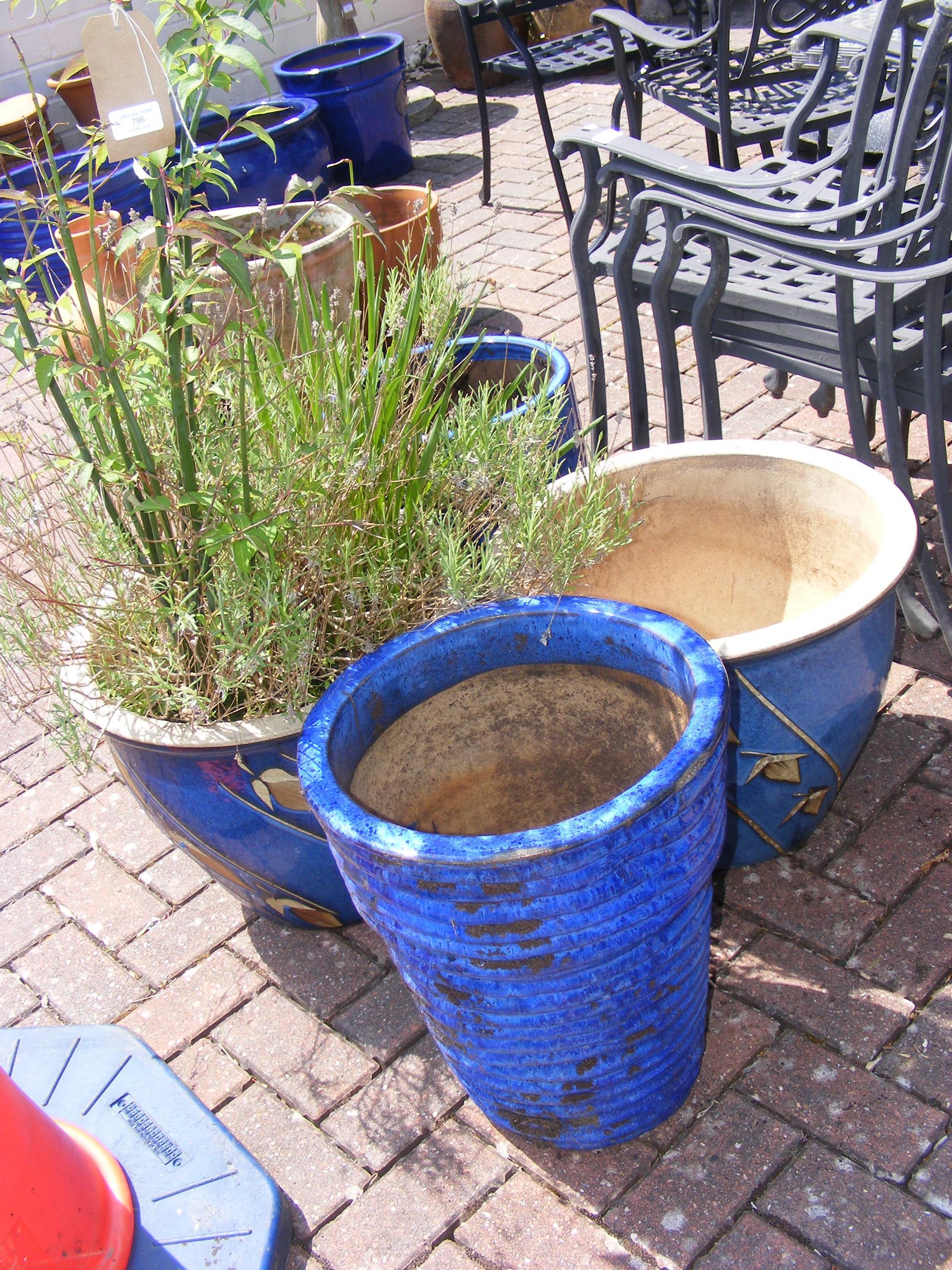 Four blue glazed garden pots of varying size