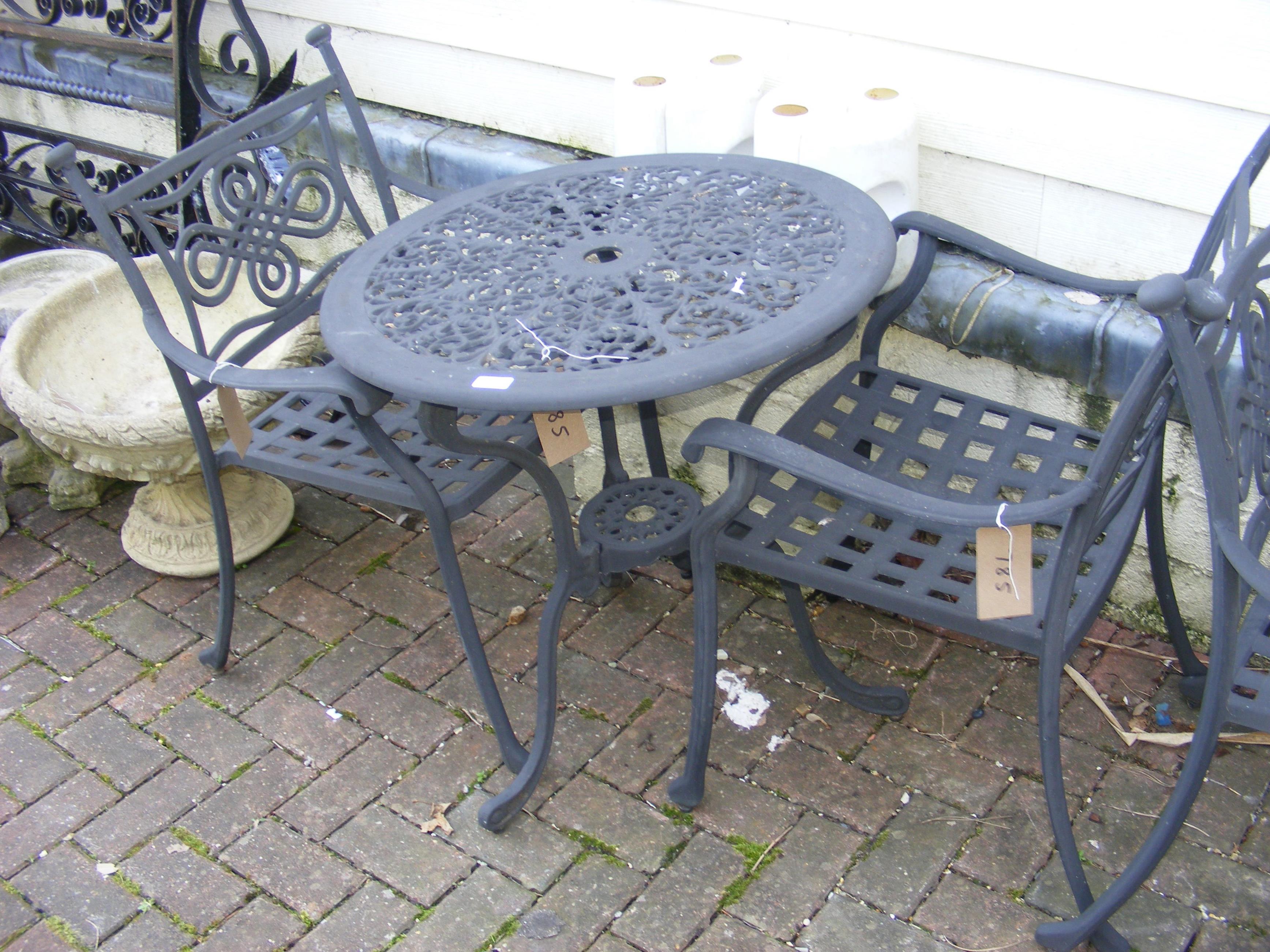 A black and metal bistro garden table with two cha