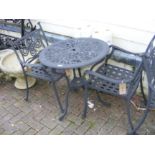 A black and metal bistro garden table with two cha