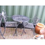 A black and metal bistro garden table with two cha