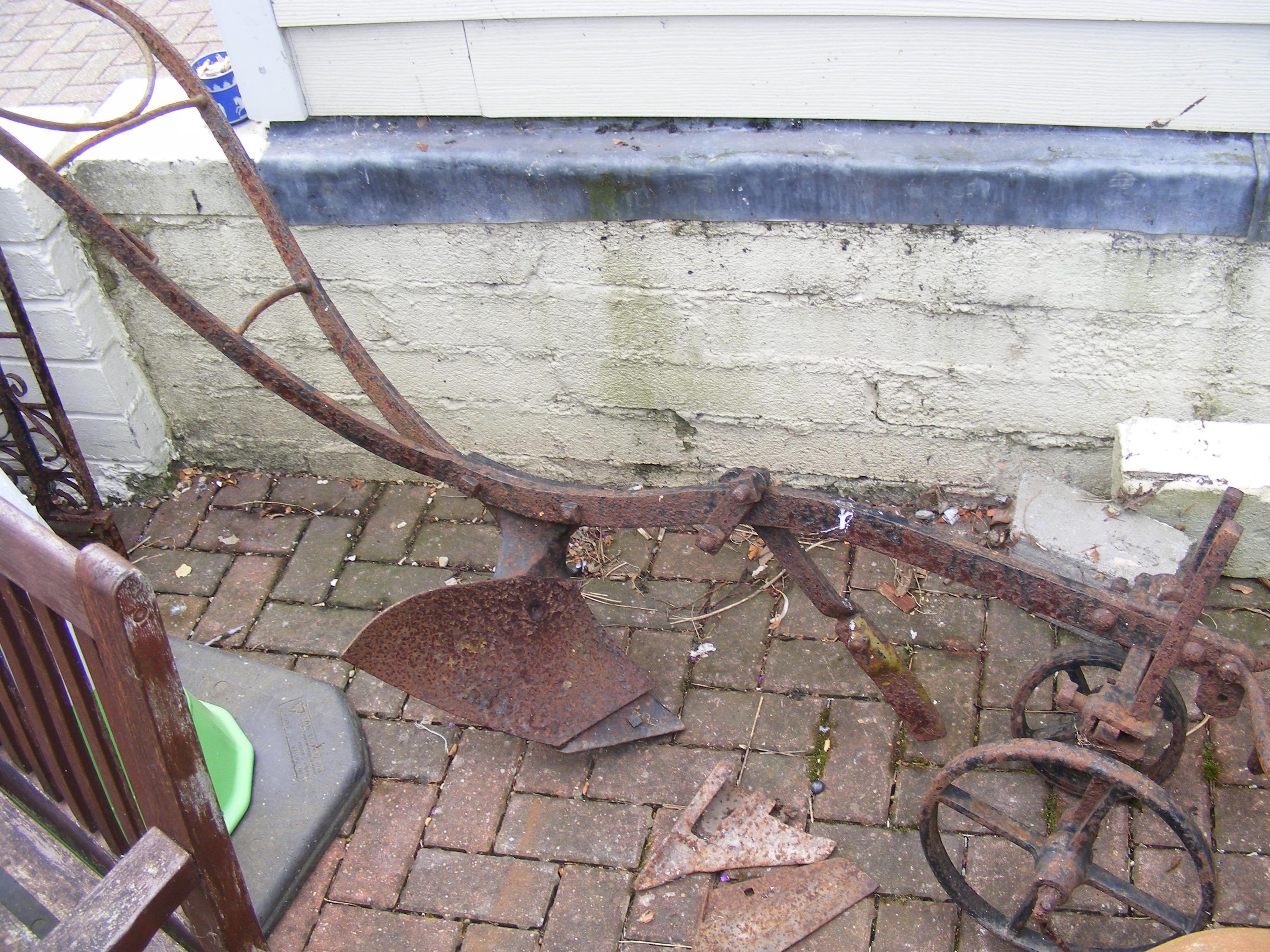 A vintage cast iron farming plough