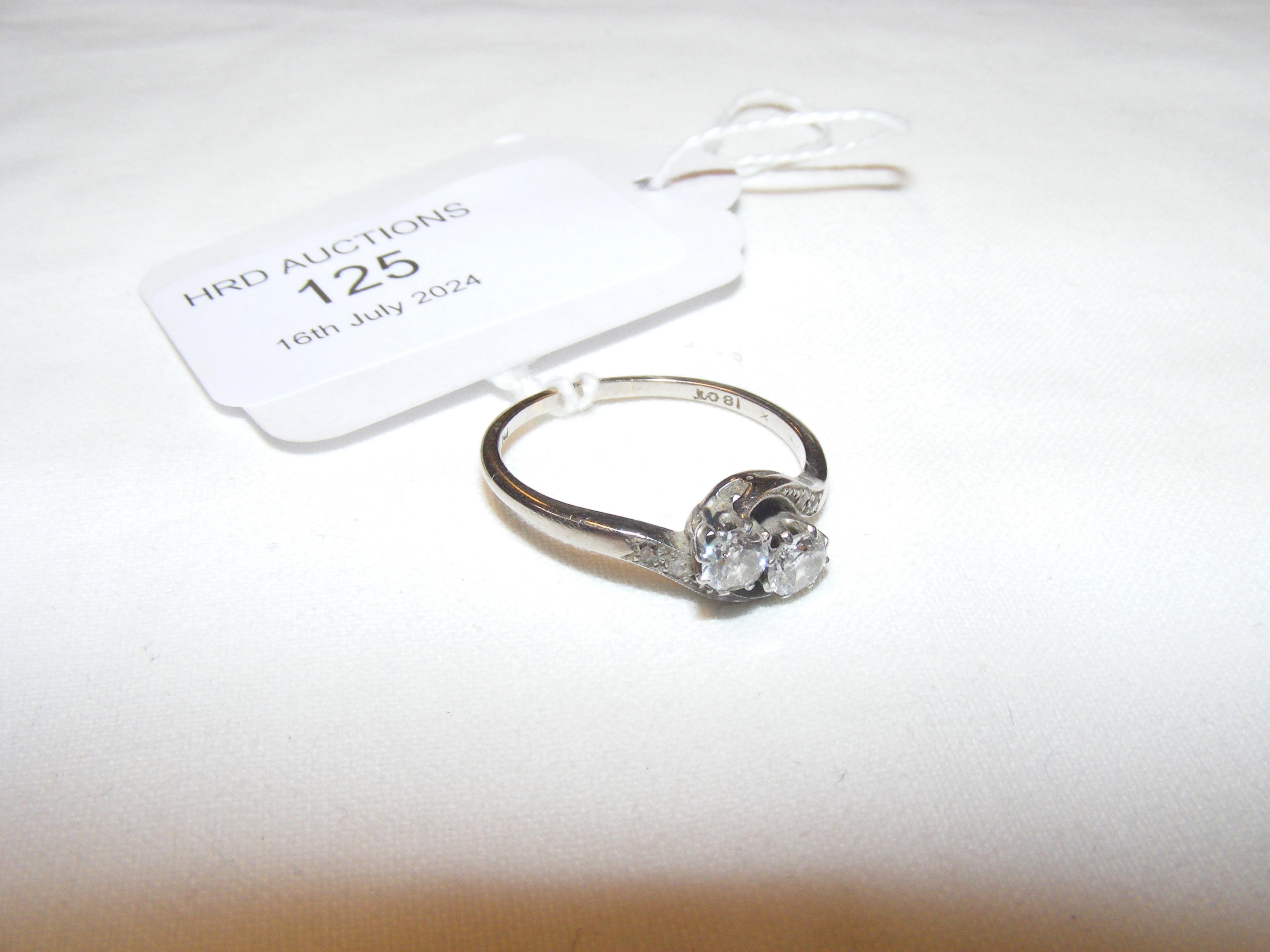 A two stone diamond crossover ring in 18ct white g