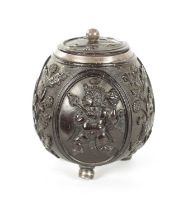 AN 18TH CENTURY EASTERN SILVER METAL MOUNTED CARVED LIDDED COCONUT