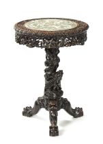 A FINE 19TH CENTURY CHINESE PROFUSELY CARVED CENTRE TABLE WITH CANTONESE PORCELAIN INSET TOP