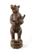 A GOOD 19TH CENTURY CARVED WALNUT BLACK FOREST STANDING BEAR STICK STAND