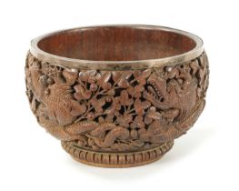 A LATE 19TH CENTURY BURMESE CARVED HARDWOOD SILVER MOUNTED BOWL