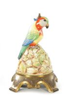 AN EARLY 20TH CENTURY DOULTON PORCELAIN AND CAST BRASS TABLE LAMP FORMED AS A PARROT