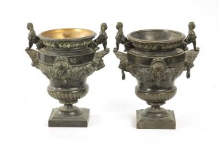 A PAIR OF LATE 19TH CENTURY CAST BRONZE EGYPTIAN STYLE URNS