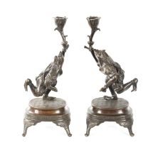 A PAIR OF JAPANESE MEIJI PERIOD PATINATED BRONZE FIGURAL CANDLESTICKS