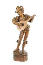 A GOOD 19TH CENTURY BLACK FOREST CARVED LINDEN WOOD FIGURE OF A MUSICIAN