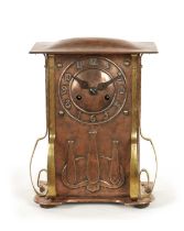AN ARTS AND CRAFT COPPER AND BRASS MANTEL CLOCK