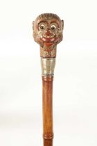 A LATE 19TH CENTURY NOVELTY WALKING STICK FORMED AS A MONKEY HEAD WITH AUTOMATON EYES AND MOUTH