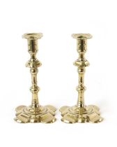 A PAIR OF EARLY 18TH CENTURY SEAMED BRASS PETAL BASE CANDLESTICKS