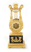 A 19TH CENTURY FRENCH ORMOLU AND VERDI ANTICO LYRE SHAPED MANTEL CLOCK